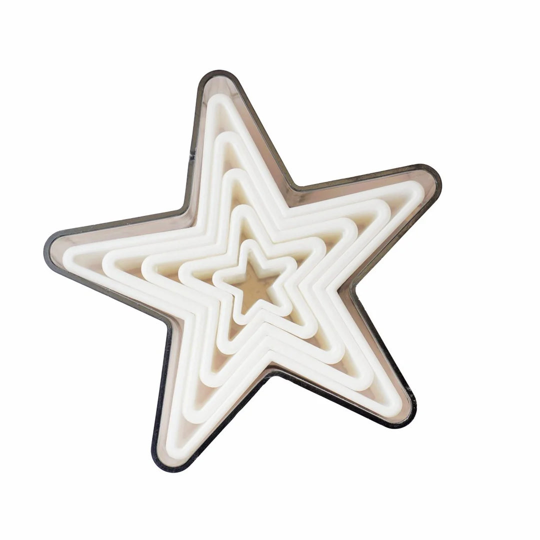 A set of five graduated star-shaped cookie cutters in different sizes, placed together in an overlapping arrangement against a white background.