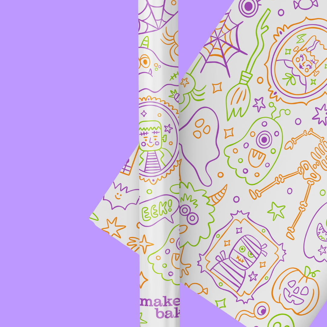 Image of a paper table runner with illustrated halloween characters creating a patterned coloring sheet for kids to color in.