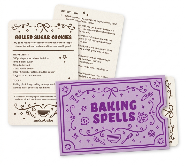 Pictures of a purple envelope labeled "Baking Spells" and example of a recipe card for Rolled Sugar Cookies on a white background.