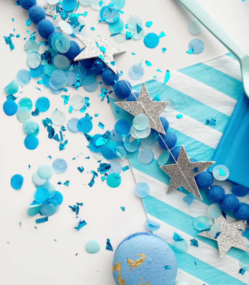 Blue and silver confetti with stars on a white background