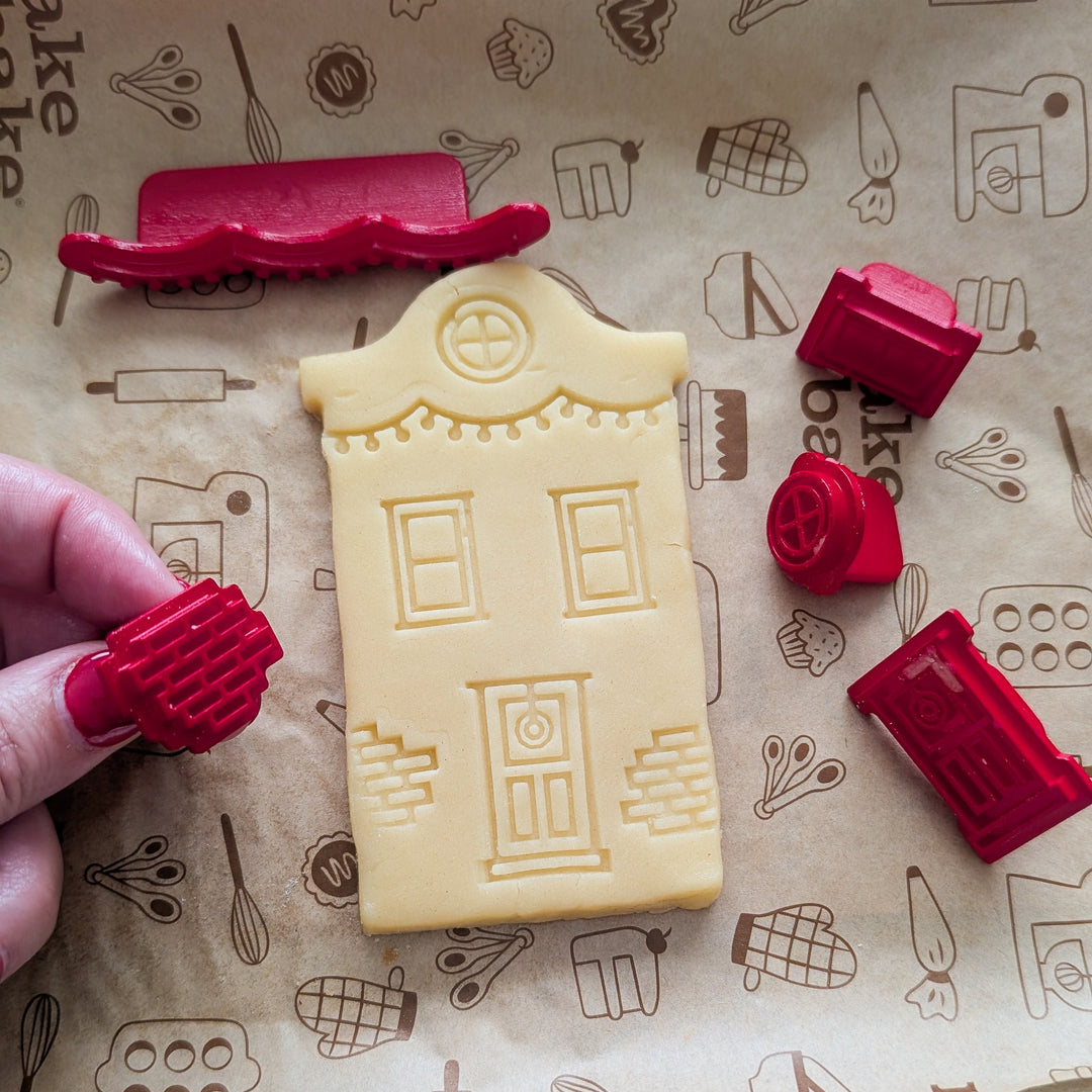 House shaped cookie stamped with house details before baking
