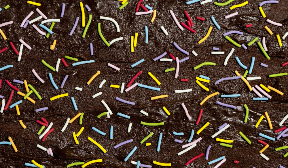 Close-up of chocolate brownie with colorful sprinkles