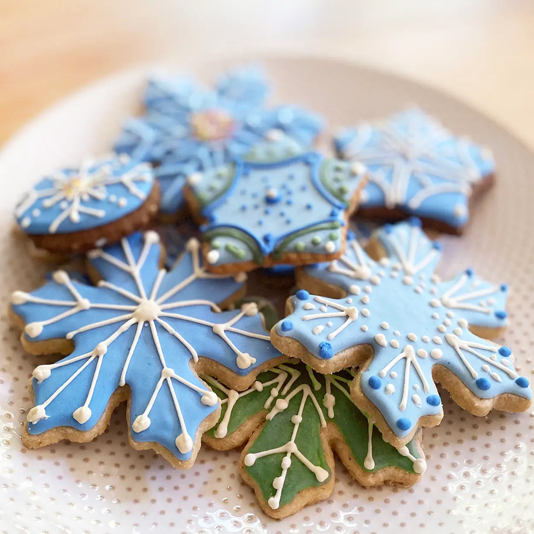 snowflake cookies decorated with dye free icing in blue and green