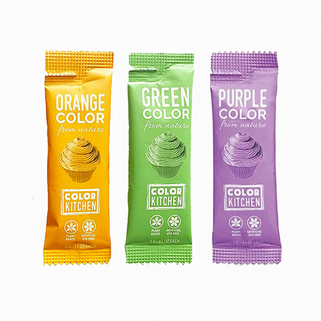 Three Color Kitchen dye-free food color pouches in orange, green, and purple on white background.