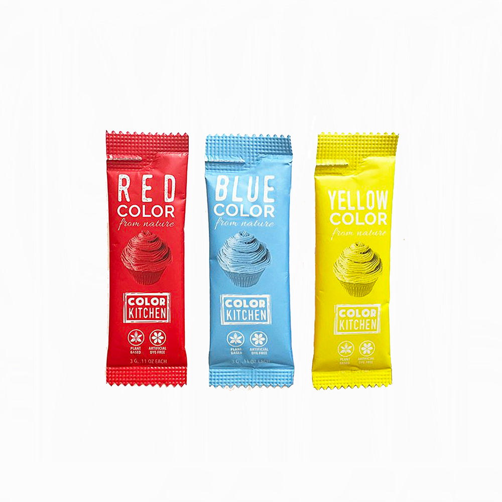 Three dye-freeColor Kitchen food color packets in red, blue, and yellow on a white background