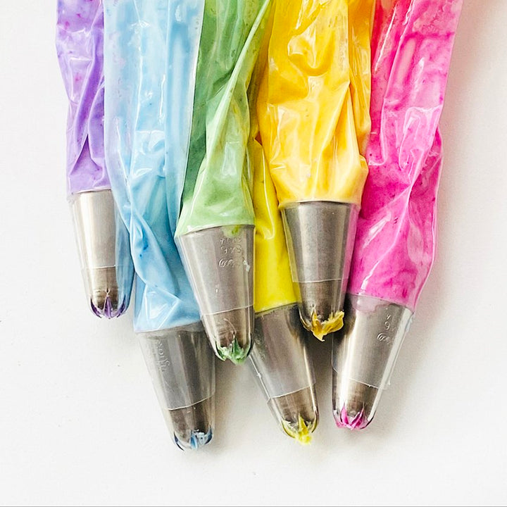 frosting in bags with piping tips in a variety of naturally vibrant colors that were made with dye-free food colors.