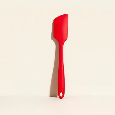 Red spatula on a beige background