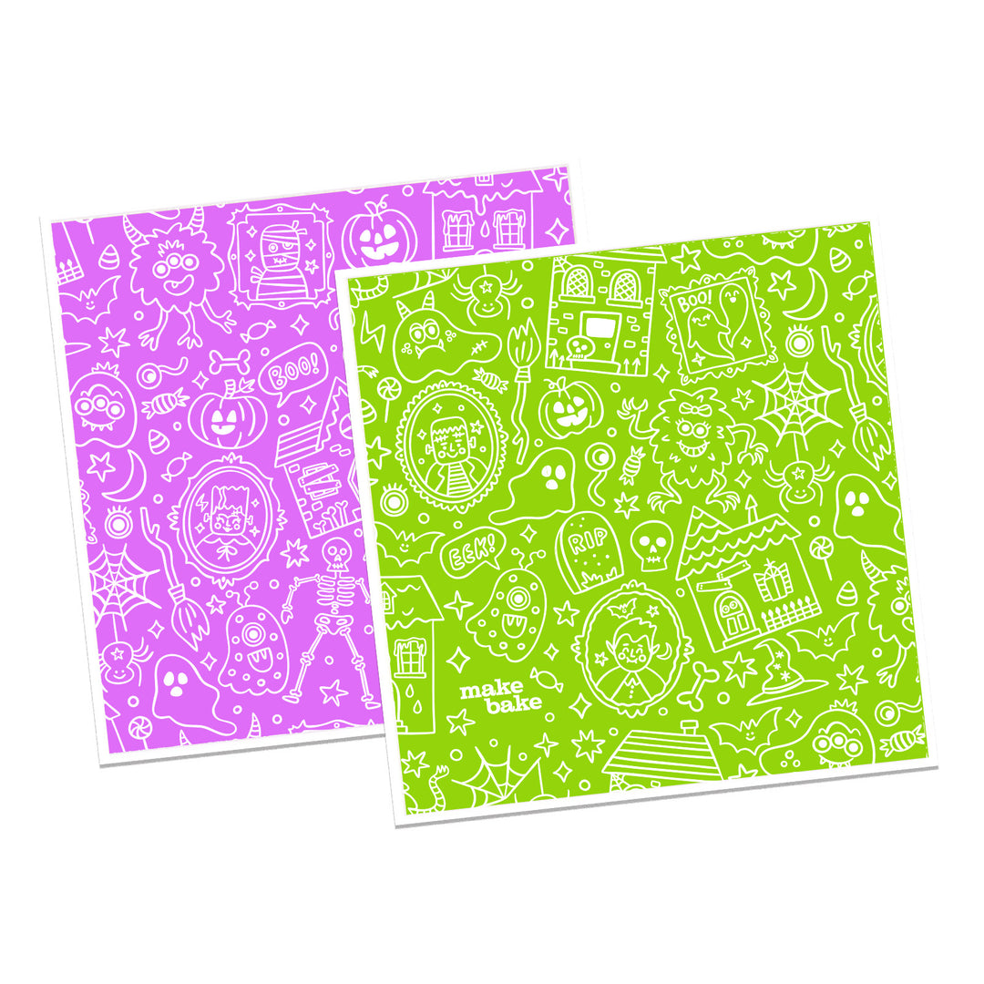 Set of two Halloween themed Swedish dishcloths. One with a design pattern in purple and one with a design pattern in green, shown on a white background