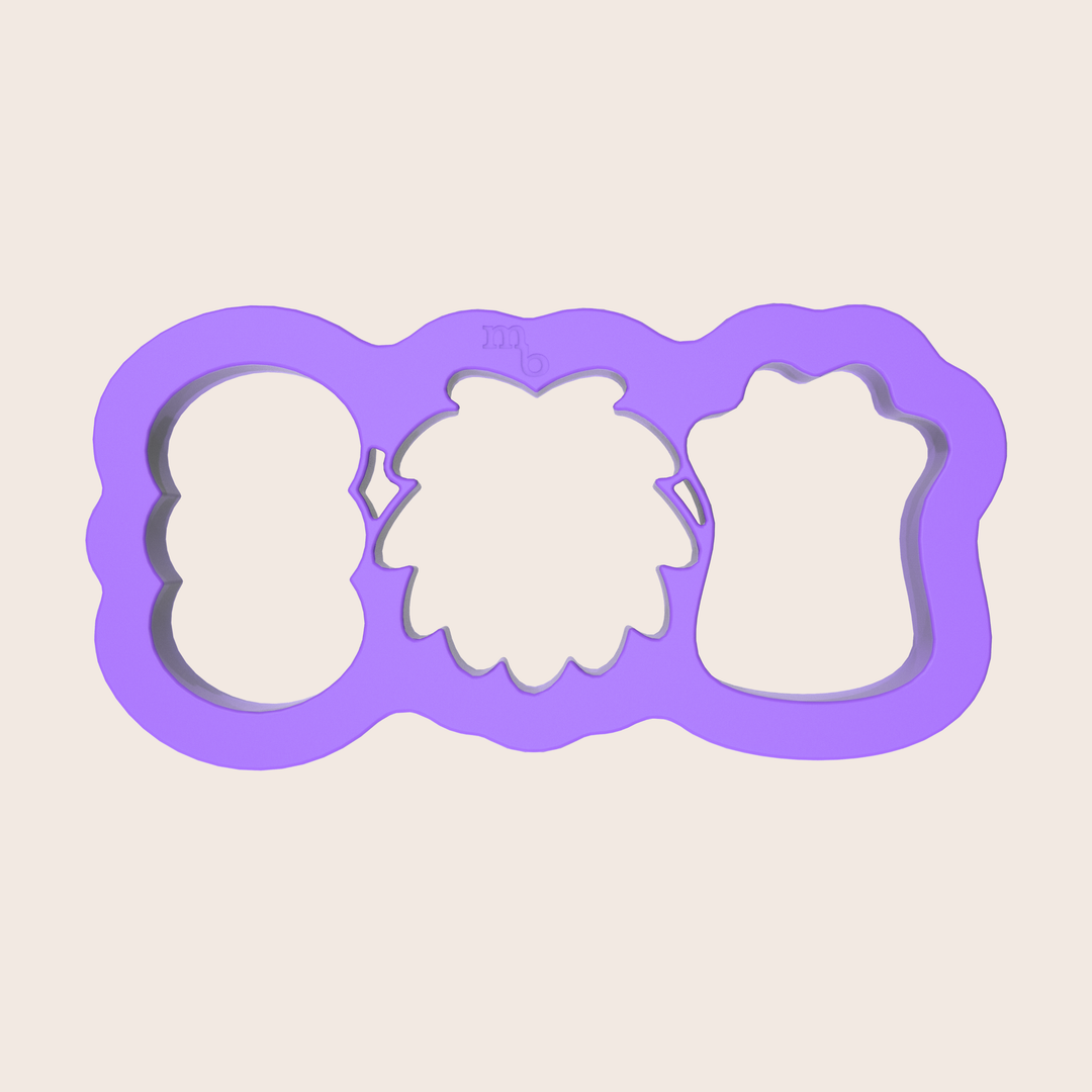 Image of purple plastic cookie cutter that cuts three monster-shaped cookies in one press.