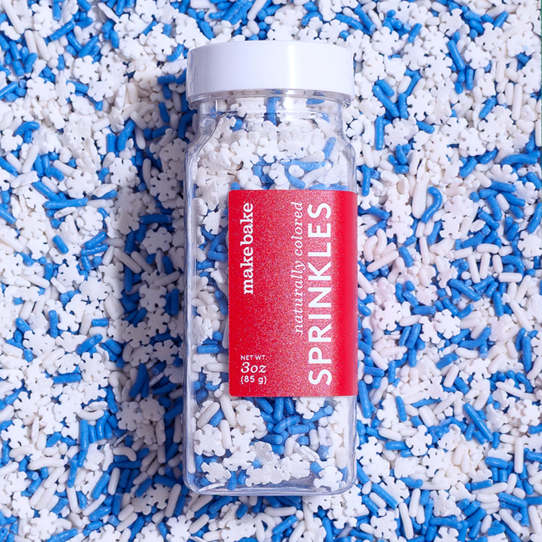 Make Bake snowflake sprinkle mix with natural blue and white sprinkles and snowflake shaped sprinkles in a bottle.