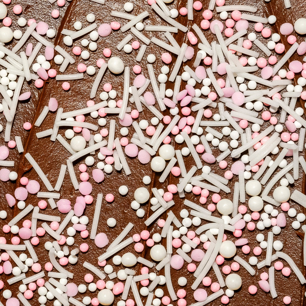 Close-up of chocolate cake with pink and white sprinkles