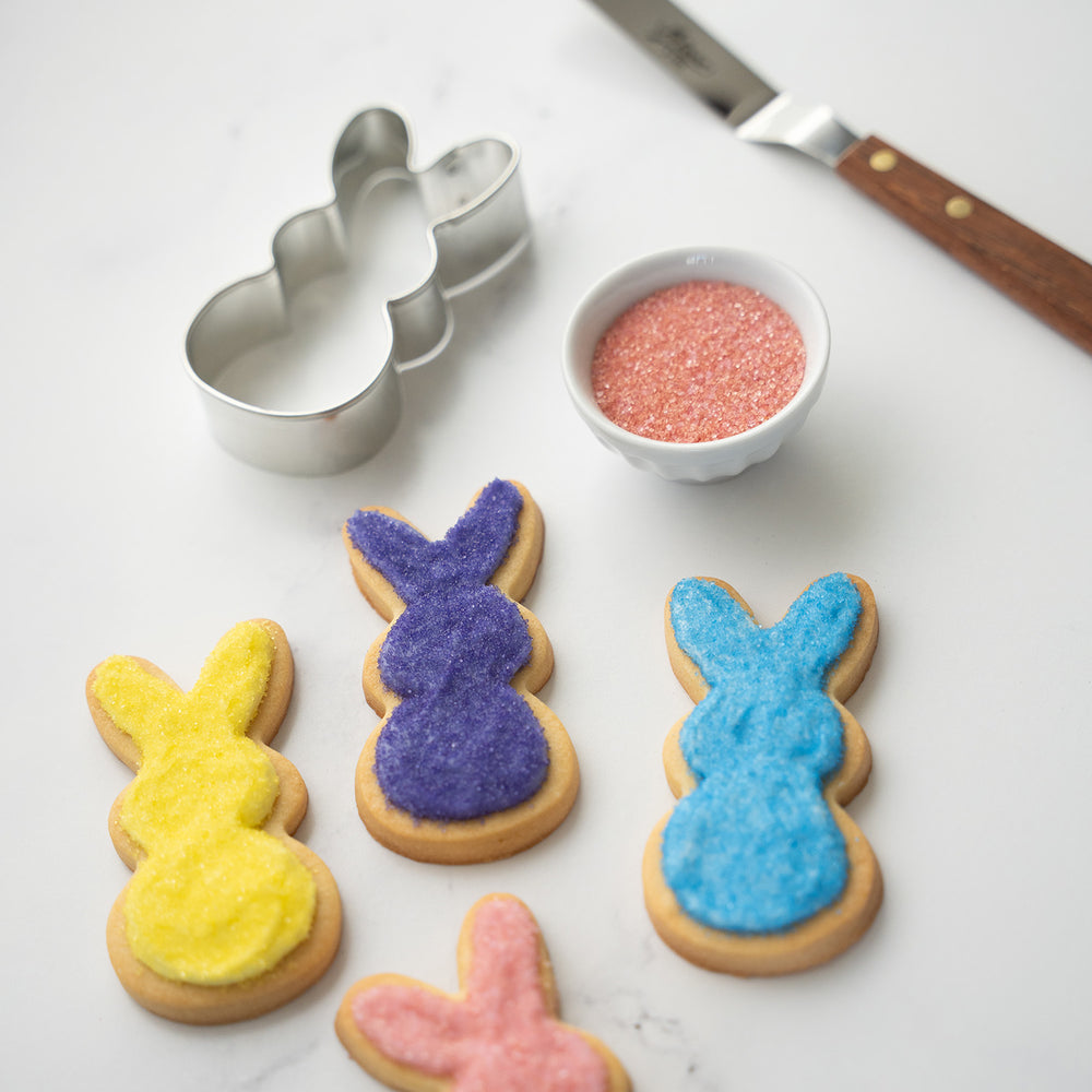 Bunny shaped sugar cookies decorated with natural sanding sugars in various colors