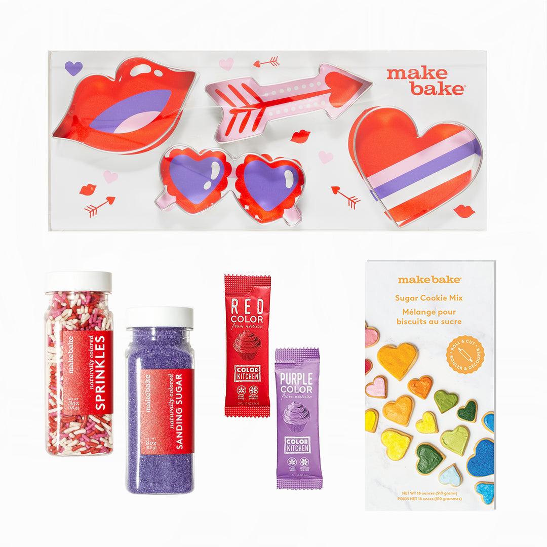 Make Bake cookie decorating kit with Valentine's Day Themed cookie cutters, dye free sanding sugars, red & purple natural food colors on a white background