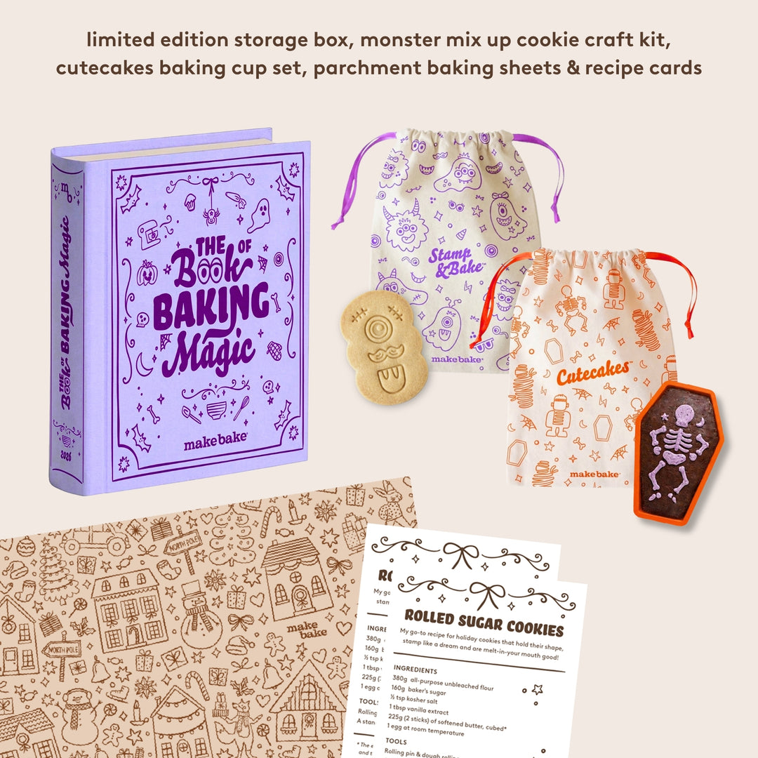 Baking kit with 'The Book of Baking Magic' and baking accessories on a beige background