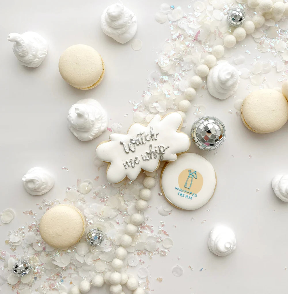 Decorative cookies with text and branding on a white surface with decorative elements.