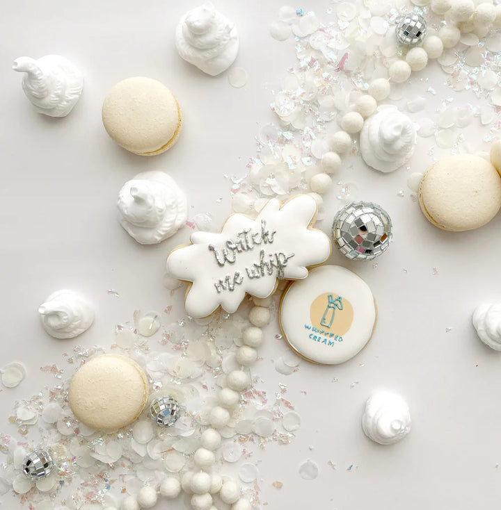 Decorative cookies with text and branding on a white surface with decorative elements.